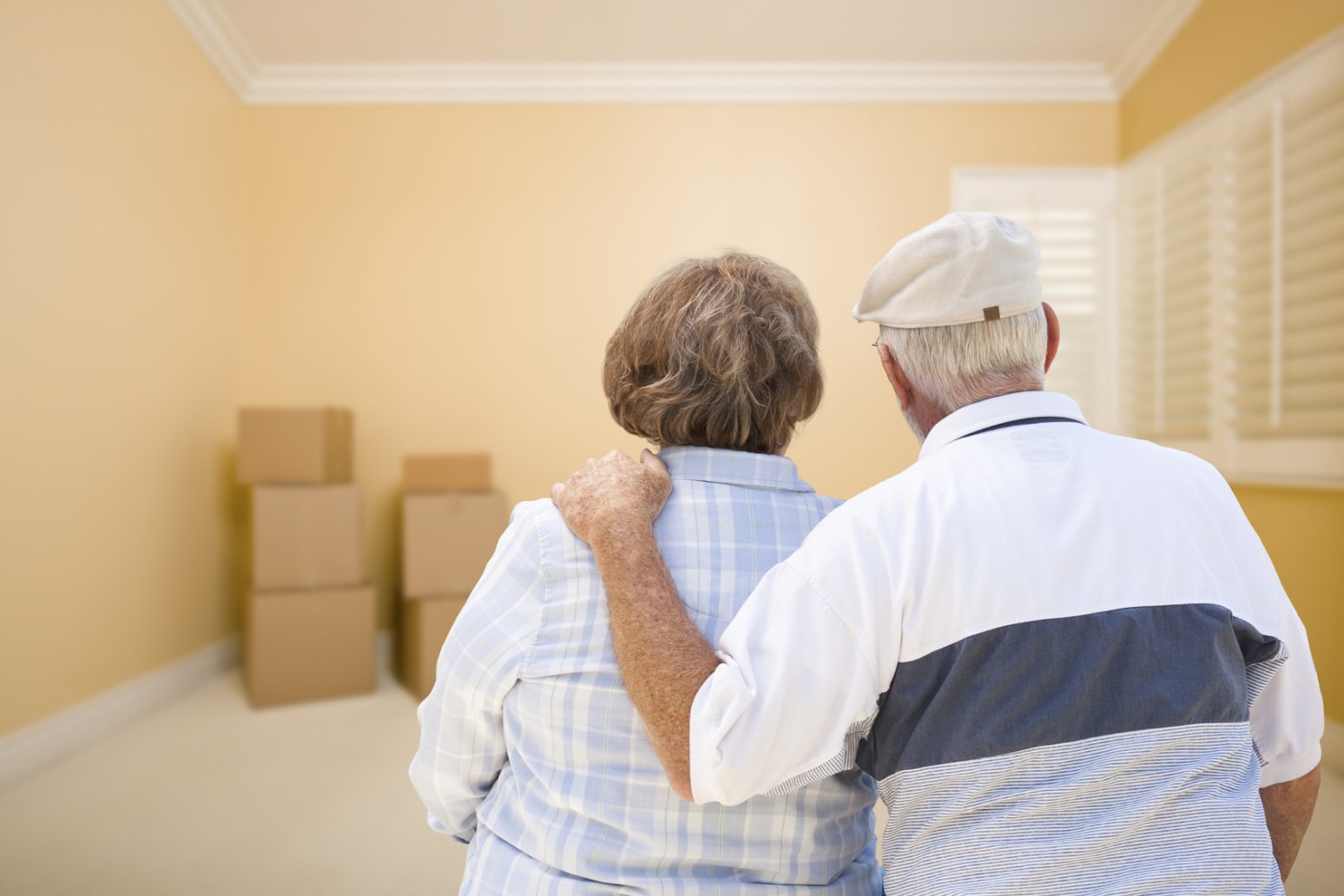 Elderly couple looking at moving boxes